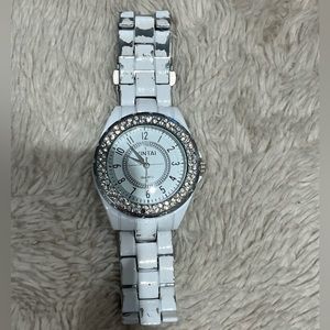 White watch with diamonds around